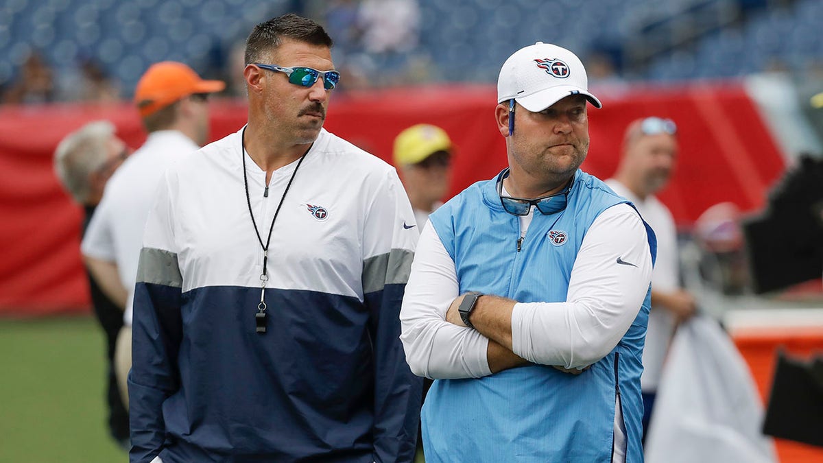 FILE - Tennessee Titans head coach Mike Vrabel, left, and general manager Jon Robinson walk on the field before a practice in Nissan Stadium during NFL football training camp Saturday, Aug. 3, 2019, in Nashville, Tenn. The Tennessee Titans have extended the contracts of general manager Jon Robinson and coach Mike Vrabel to keep them around for years to come, Tuesday, Feb. 8, 2022.
