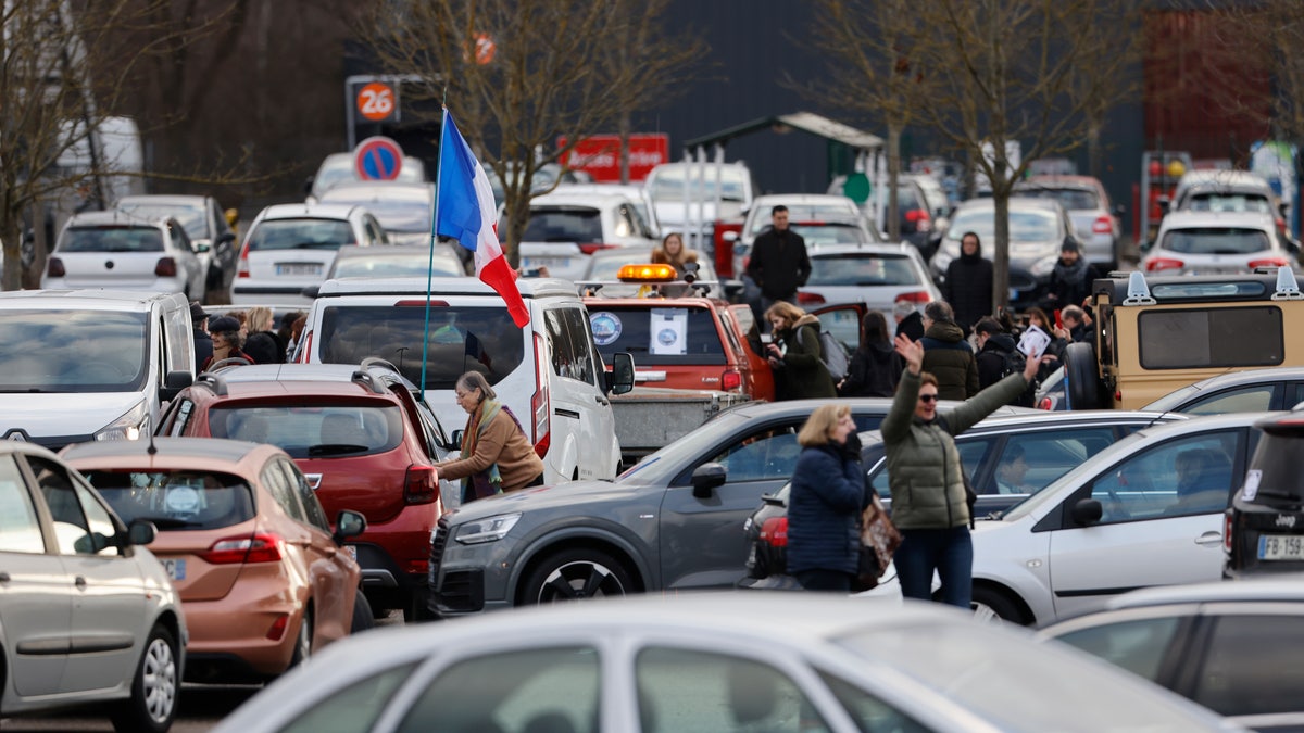 Protesters gather for a convoy before heading to Paris, Friday, Feb.11, 2022 in Strasbourg, eastern France.