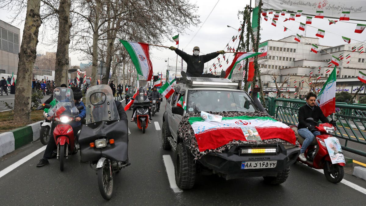 Feb. 11, 2022: People parade with Iran's flags during the annual rally commemorating anniversary of1979 Islamic Revolution in Azadi (freedom) Square in Tehran, Iran. 