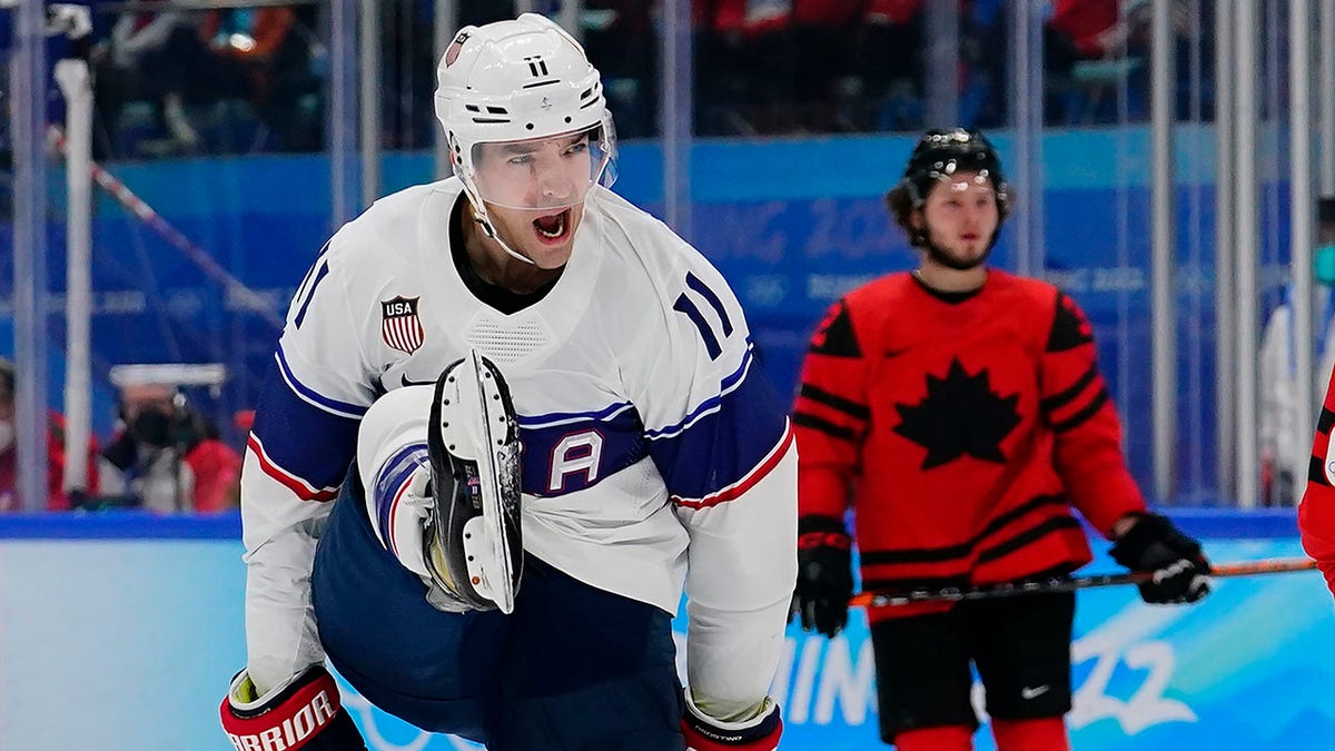 United States' Kenny Agostino (11) celebrates after scoring a goal against Canada during a preliminary round men's hockey game at the 2022 Winter Olympics, Saturday, Feb. 12, 2022, in Beijing.