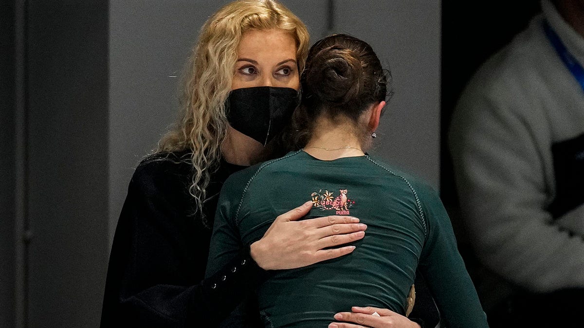 Coach Eteri Tutberidze, left, embraces Kamila Valieva, of the Russian Olympic Committee, during a training session at the 2022 Winter Olympics, Saturday, Feb. 12, 2022, in Beijing.
