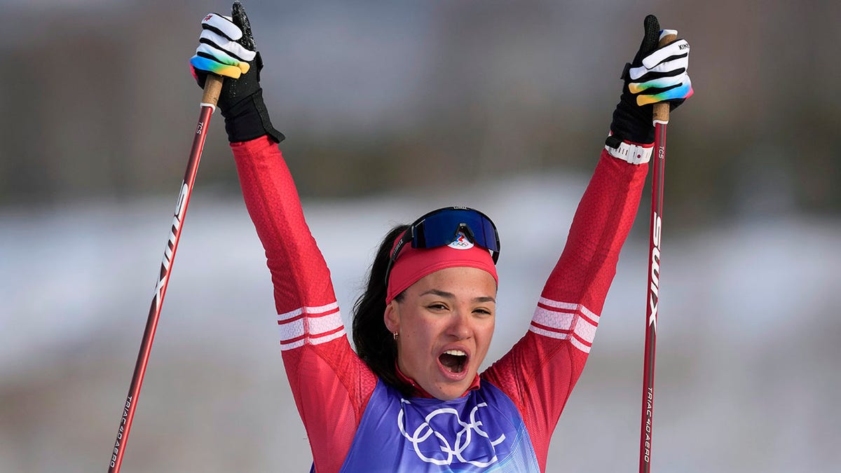 Veronika Stepanova, of the Russian Olympic Committee, celebrates after crossing the finish line during the women's 4 x 5km relay cross-country skiing competition at the 2022 Winter Olympics, Saturday, Feb. 12, 2022, in Zhangjiakou, China.