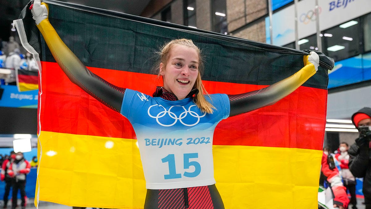 Hannah Neise, of Germany, celebrate winning the gold medal in the women's skeleton at the 2022 Winter Olympics, Saturday, Feb. 12, 2022, in the Yanqing district of Beijing.