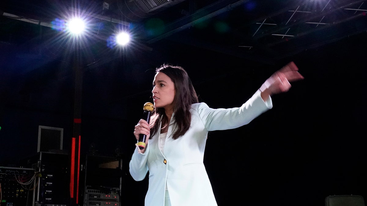 Alexandria Ocasio Cortez speaking on stage