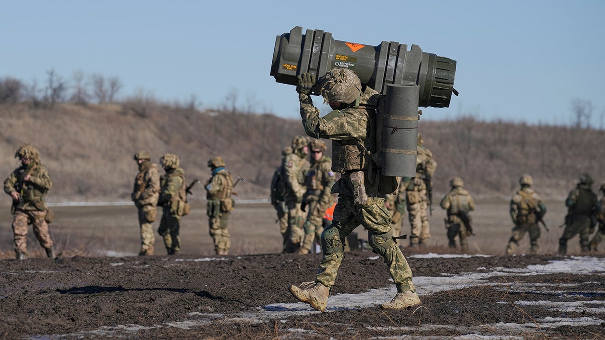 A Ukrainian serviceman carries an NLAW anti-tank weapon during an exercise in the Joint Forces Operation, in the Donetsk region, eastern Ukraine, Feb. 15, 2022.