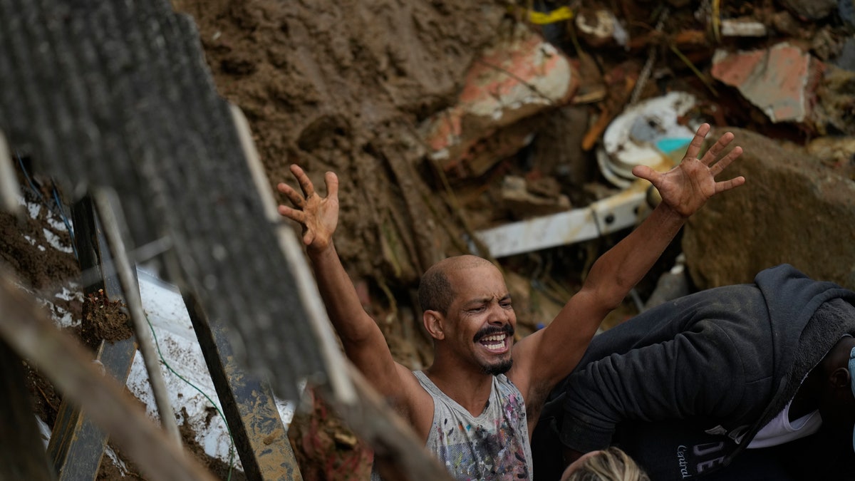 A resident yells during the search for survivors after fatal mudslides in Petropolis, Brazil, Wednesday, Feb. 16, 2022.
