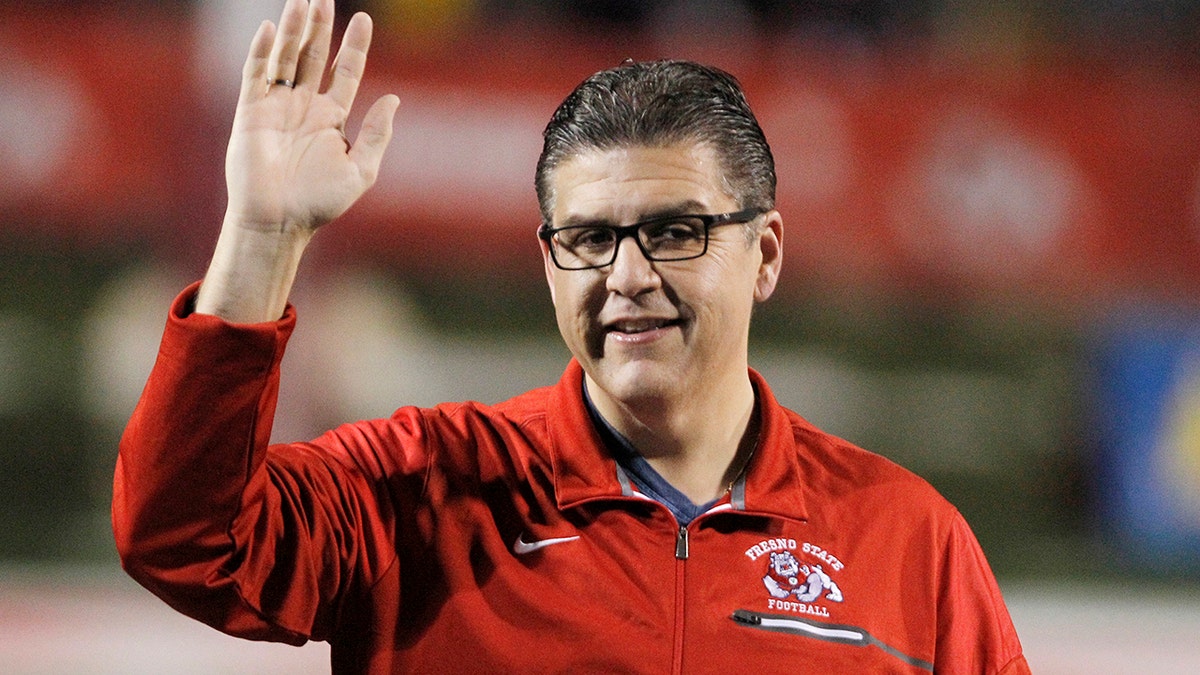 Joseph I. Castro, at the time president of Fresno State, waves to the crowd before the team's NCAA college football game Nov. 4, 2017, against BYU in Fresno, Calif. (AP Photo/Gary Kazanjian, File)