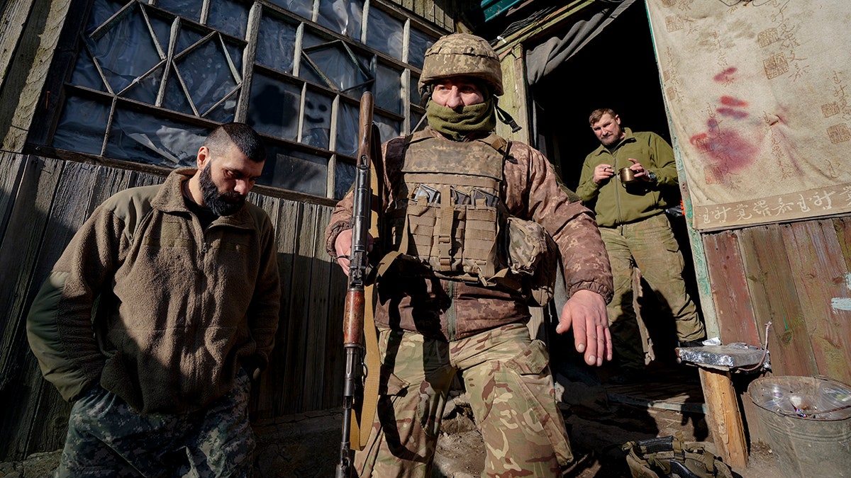 A Ukrainian serviceman leaves a command post to start his shift at a front-line position outside Popasna, in the Luhansk region, eastern Ukraine, Sunday, Feb. 20, 2022.