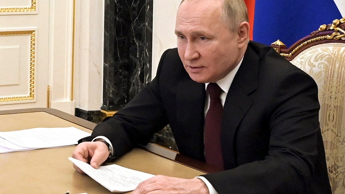Russian President Vladimir Putin talks via videoconference with members of the Russian Paralympic Committee team on the eve of the XIII Paralympic Winter Games in Beijing, in Moscow, Russia, Monday, Feb. 21, 2022.