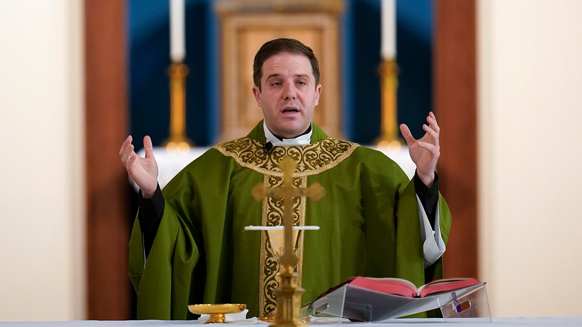 Father Matthew Hood celebrates mass at Our Lady of the Rosary church Friday, Feb. 18, 2022, in Detroit. (AP Photo/Paul Sancya)