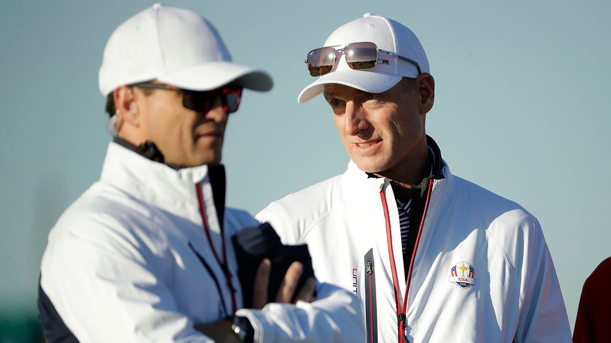 FILE - U.S. team captain Jim Furyk, right, stands alongside vice-captain Zach Johnson on the driving range at Le Golf National in Guyancourt, outside Paris, France, Tuesday, Sept. 25, 2018. The AP has learned Johnson has been selected as captain for the 2023 Ryder Cup in Italy.