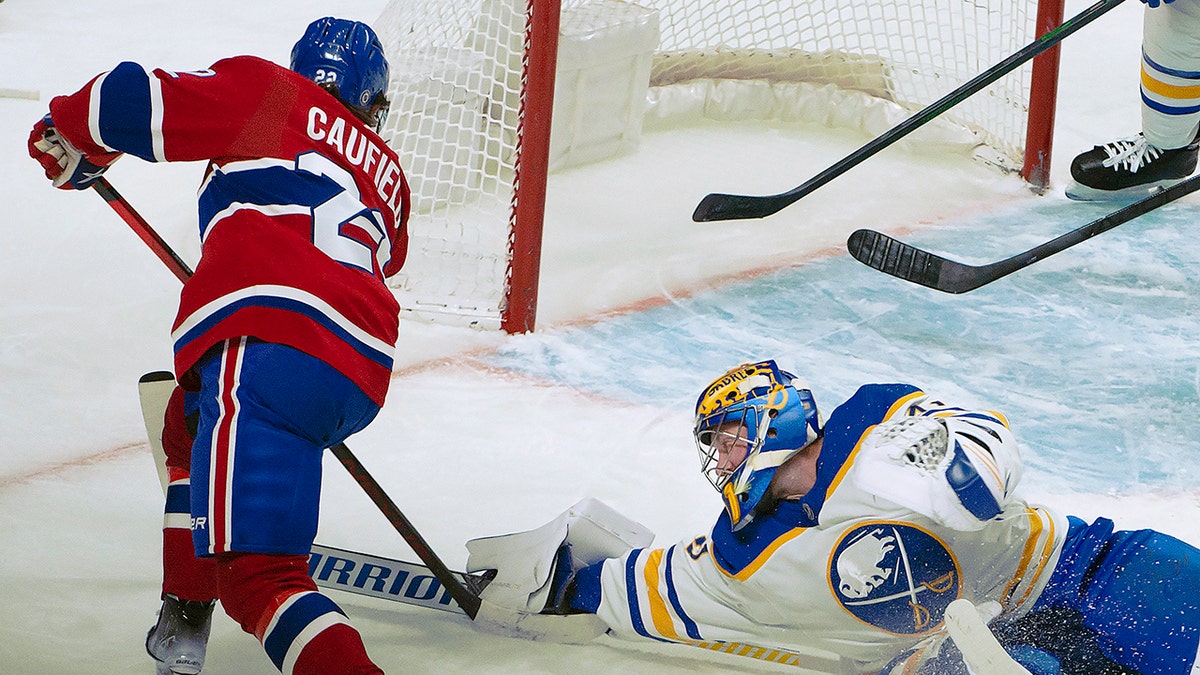 Buffalo Sabres goalie Craig Anderson stops a shot from Montreal Canadiens right wing Cole Caufield (22) during the first period of an NHL hockey game Wednesday, Feb. 23, 2022, in Montreal. 