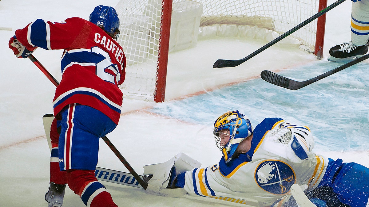 Buffalo Sabres goalie Craig Anderson stops a shot from Montreal Canadiens right wing Cole Caufield (22) during the first period of an NHL hockey game Wednesday, Feb. 23, 2022, in Montreal.