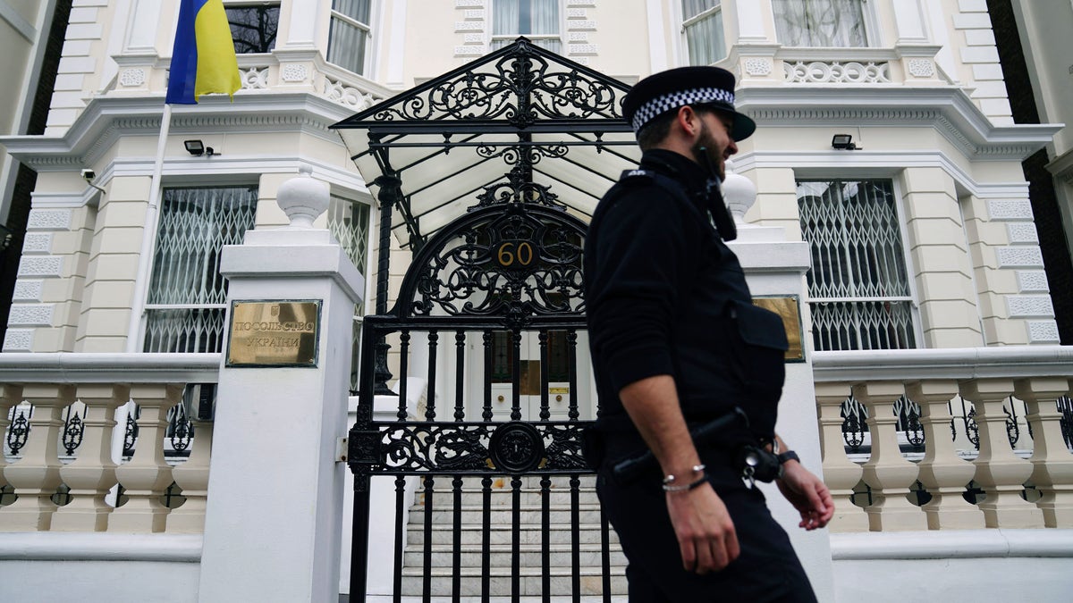 A police officer walks past the Ukrainian Embassy in west London, Thursday, Feb. 24, 2022, following Russia's attack on Ukraine.  World leaders expressed a raw outrage shrouded by an impotence to immediately come to the aid of Ukraine to avoid a major war in Europe, condemning Russia’s attack on its neighbor as the European Union and others promised unprecedented sanctions to hit the Kremlin. 
