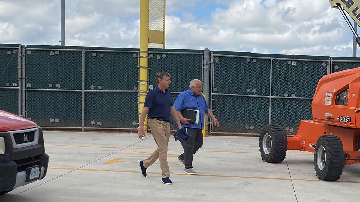 New York Yankees managing general partner Hal Steinbrenner, left, and San Diego Padres vice chairman Ron Fowler walk at Roger Dean Stadium in Jupiter, Fla., where baseball labor talks continue Thursday, Feb. 24, 2022.