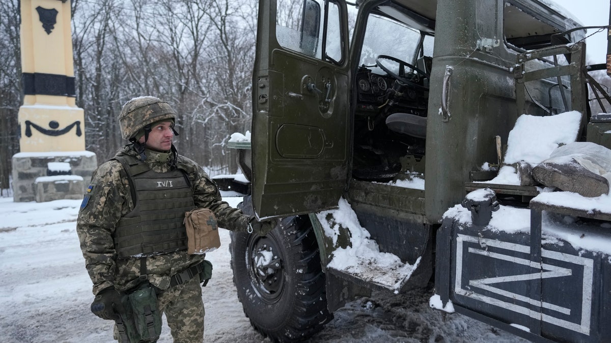 A Ukrainian serviceman opens the door of a deactivated Russian military multiple rocket launcher on the outskirts of Kharkiv, Ukraine, on Friday, Feb. 25, 2022. Russian troops bore down on Ukraine's capital Friday, with gunfire and explosions resonating ever closer to the government quarter, in an invasion of a democratic country that has fueled fears of wider war in Europe and triggered worldwide efforts to make Russia stop.