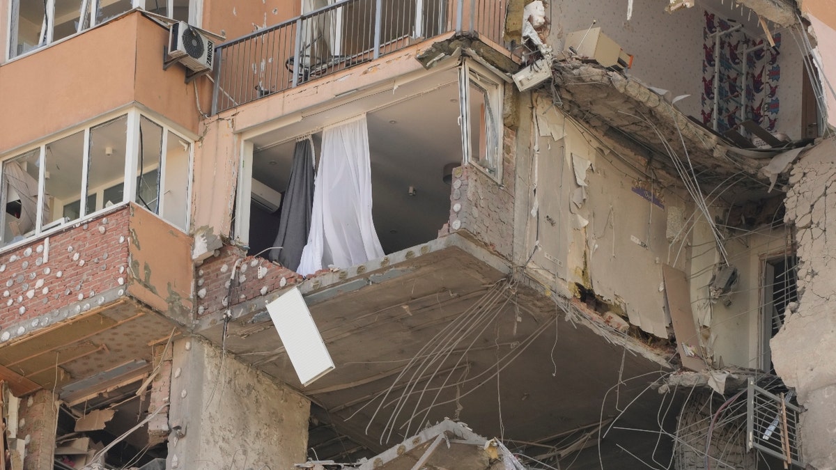 An apartment building damaged following a rocket attack on the city of Kyiv, Ukraine, Saturday, Feb. 26, 2022. Russian troops stormed toward Ukraine's capital Saturday, and street fighting broke out as city officials urged residents to take shelter. (AP Photo/Efrem Lukatsky)