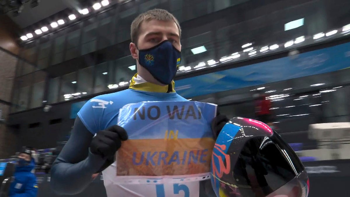 FILE - In this frame from video, Vladyslav Heraskevych, of Ukraine, holds a sign that reads "No War in Ukraine" after finishing a run at the men's skeleton competition at the 2022 Winter Olympics, Friday, Feb. 11, 2022, in the Yanqing district of Beijing.