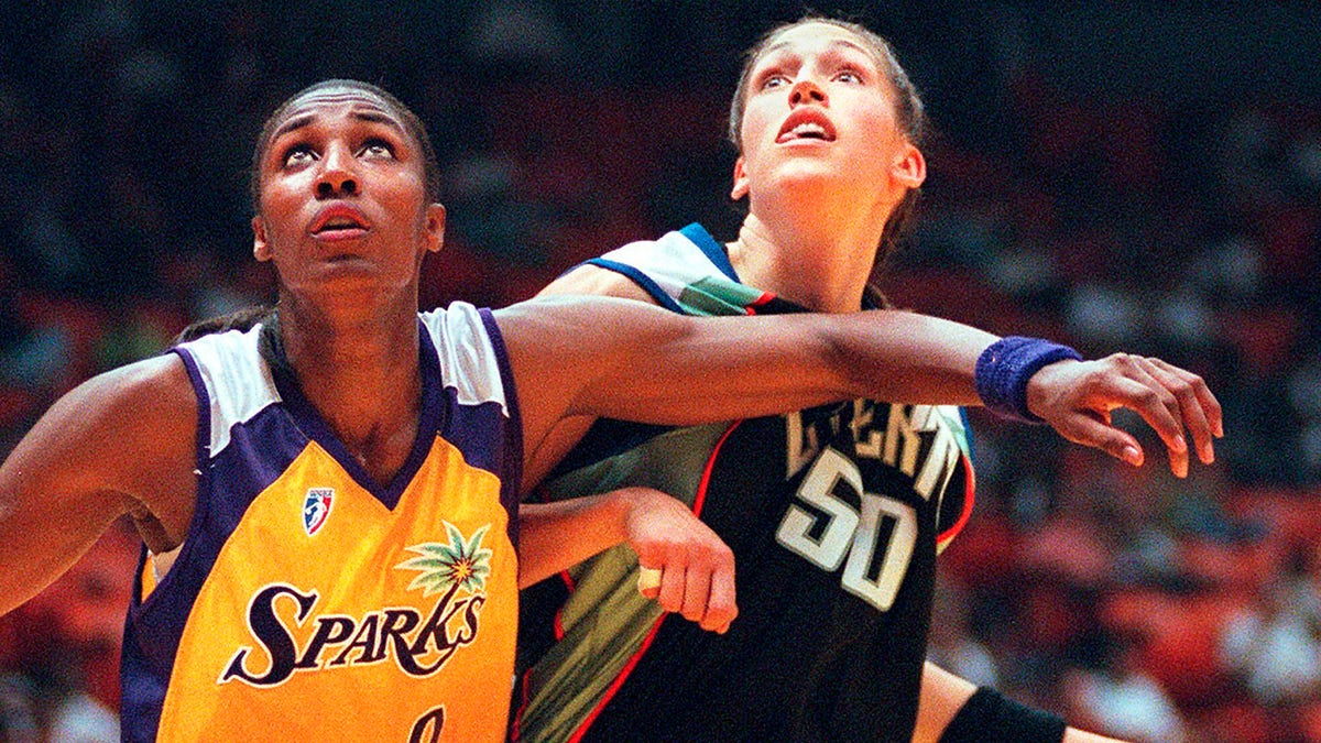FILE - Los Angeles Sparks' Lisa Leslie, left, and the New York Liberty's Rebecca Lobo battle for rebound position during the first half of a WNBA basketball game in Inglewood, Calif. The NBA recognized the popularity of the women's game with the league's Board of Governors approving plans to start a new pro basketball league in the summer of 1997.
