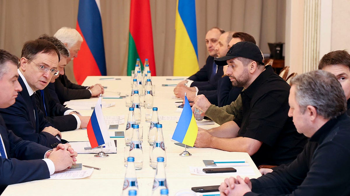 Vladimir Medinsky, head of the Russian delegation, second left, and Davyd Arakhamia, faction leader of the Servant of the People party in the Ukrainian Parliament, third right, attend the peace talks in Gomel region, Belarus, Monday, Feb. 28, 2022.