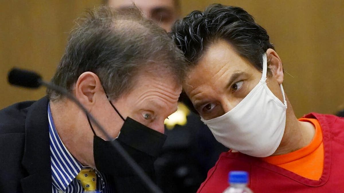 Scott Peterson, right, talks with attorney Cliff Gardner during a hearing at the San Mateo County Superior Court in Redwood City, Calif., Monday, Feb. 28, 2022. In 2004, Peterson was convicted of the murders of his wife, Laci Peterson, 27, who was eight months pregnant, and of the unborn son they planned to name Conner.