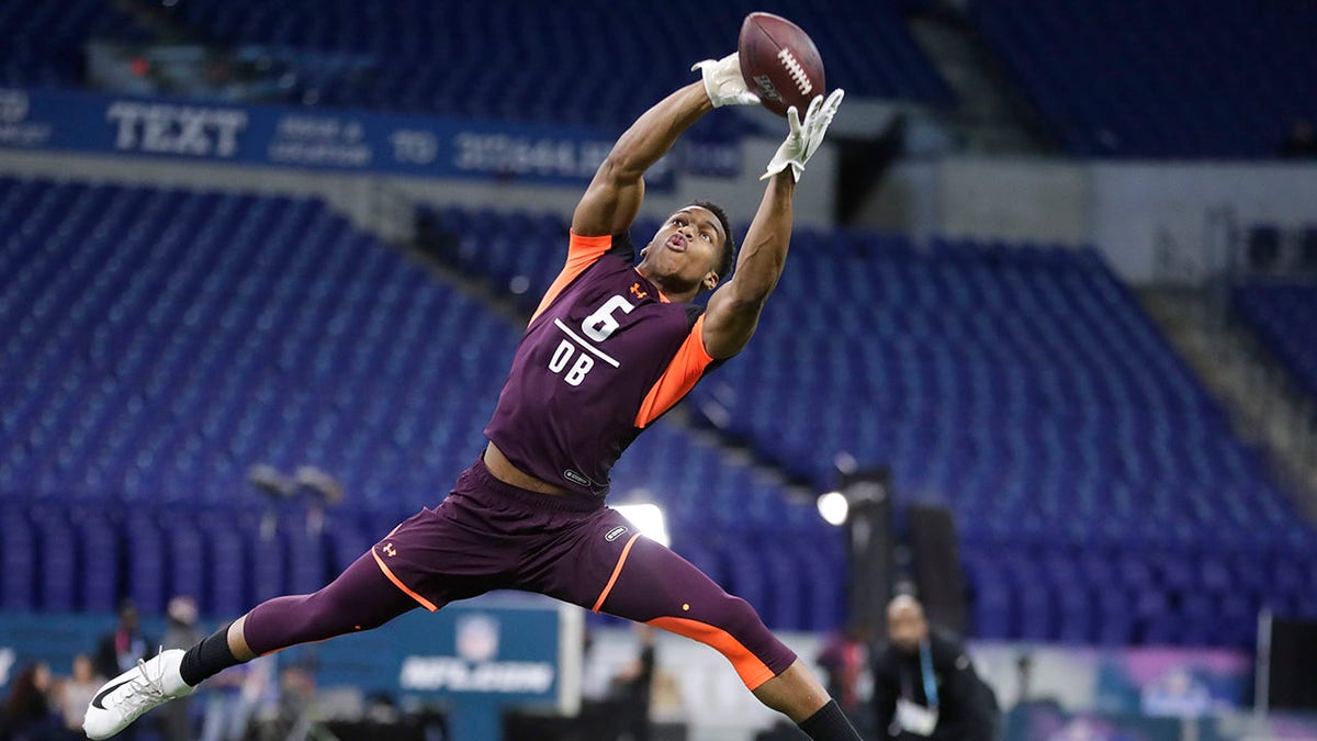 FILE - Troy defensive back Blace Brown runs a drill at the NFL football scouting combine in Indianapolis, Monday, March 4, 2019. This week’s stodgy, old NFL scouting combine is going Hollywood. The sound of silence will be replaced by music as players work out inside. Results and interviews will appear on the stadium’s video boards. Fans even will be encouraged to cheer.