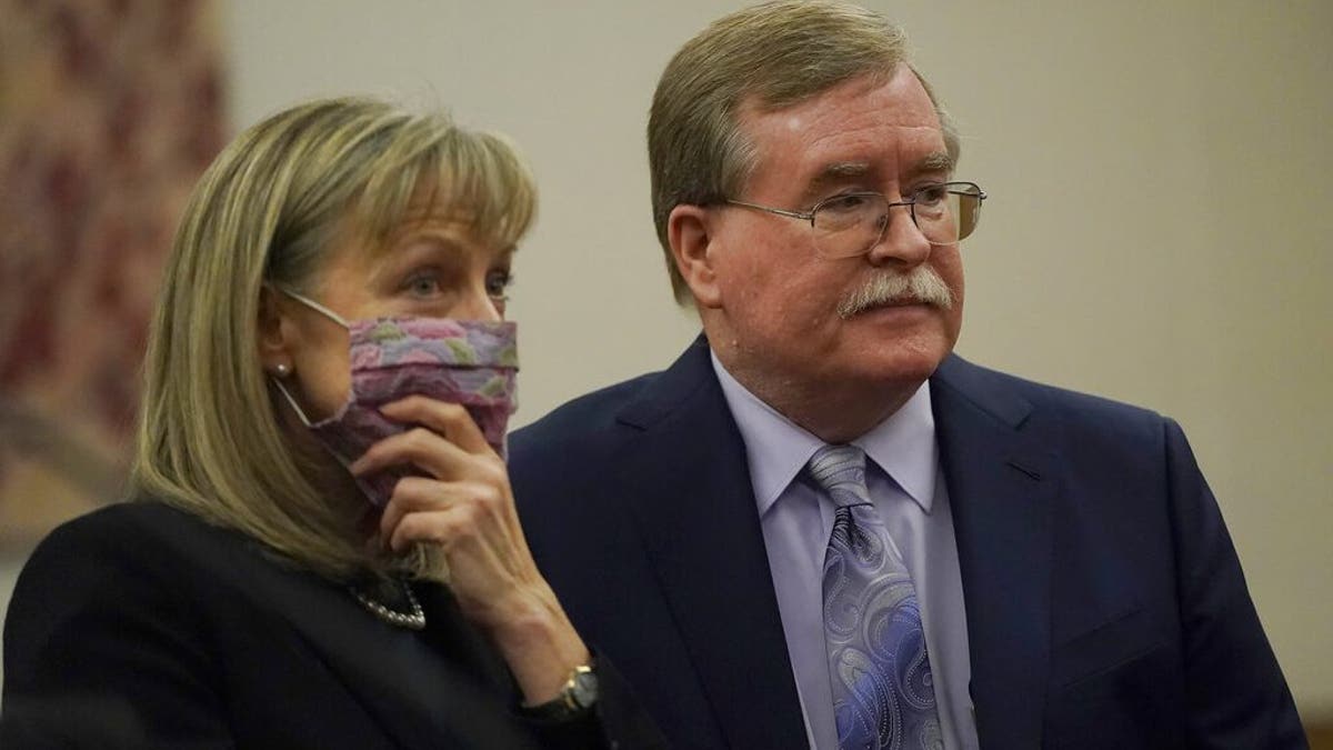David Harris, right, and Birgit Fladager, both of the Stanislaus County District Attorney's office, stand during a break in a hearing at San Mateo County Superior Court in Redwood City, Calif., Monday, Feb. 28, 2022.