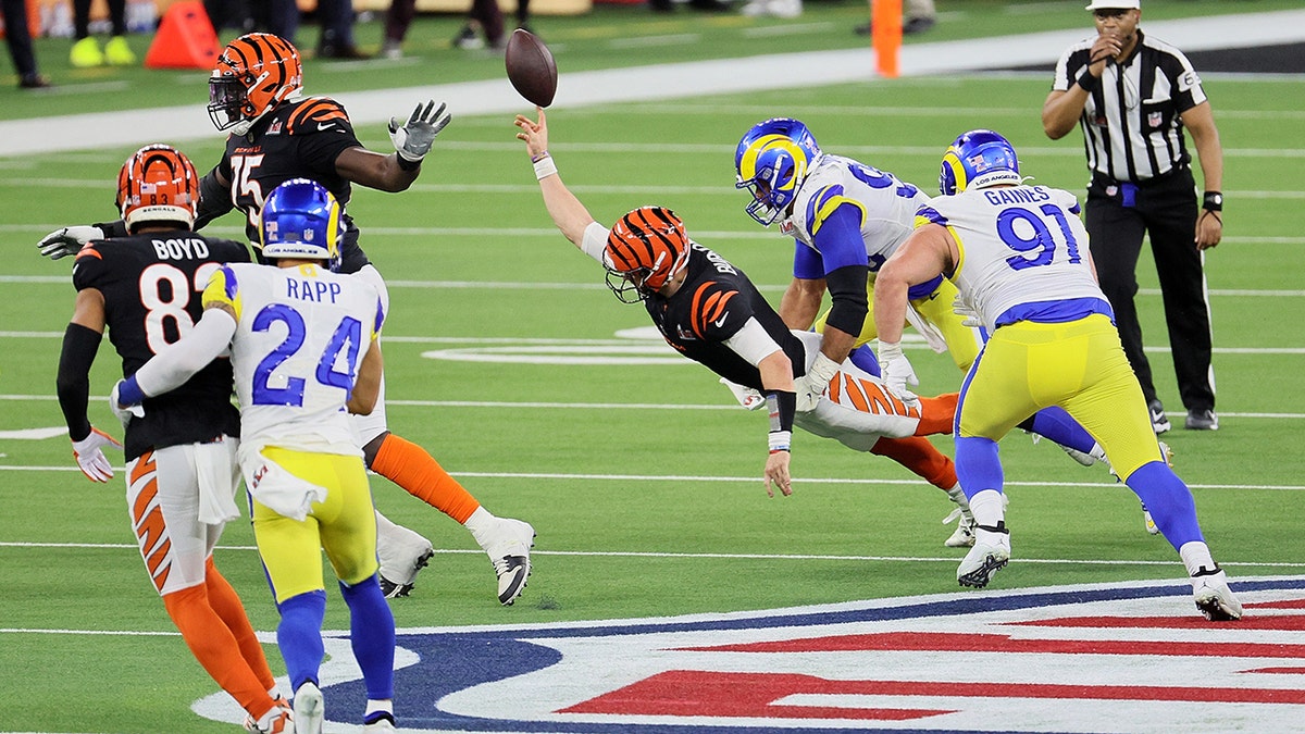Joe Burrow #9 of the Cincinnati Bengals is sacked by Aaron Donald #99 of the Los Angeles Rams in the fourth quarter during Super Bowl LVI at SoFi Stadium on February 13, 2022 in Inglewood, California.