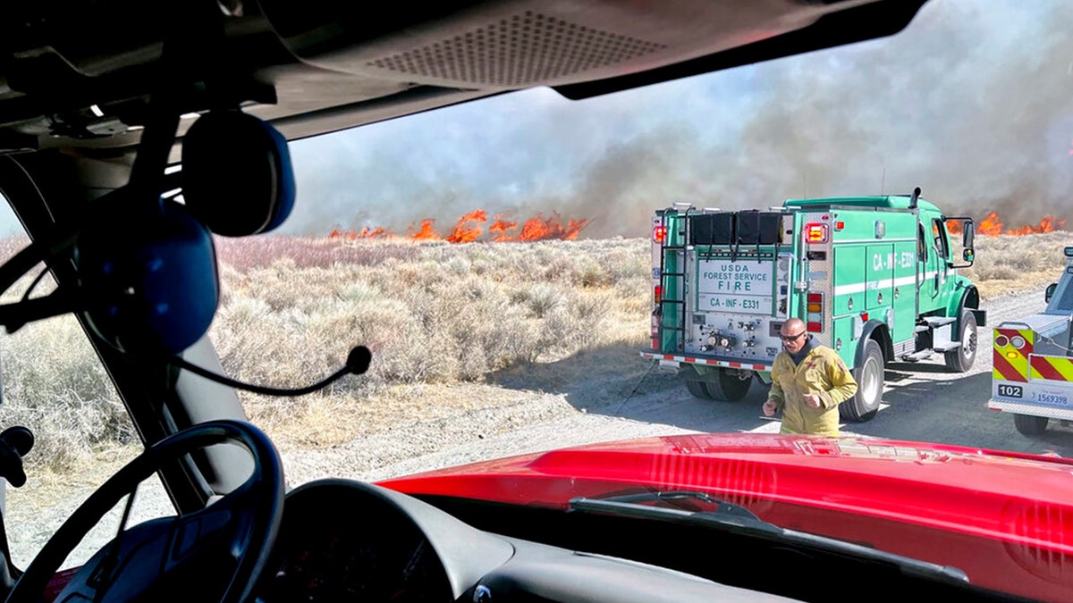 This photo provided by CAL FIRE San Bernardino Unit Public Information Office shows firefighters responding to a wildfire near in Owens Valley, Calif. on Thursday, Feb. 17, 2022. 