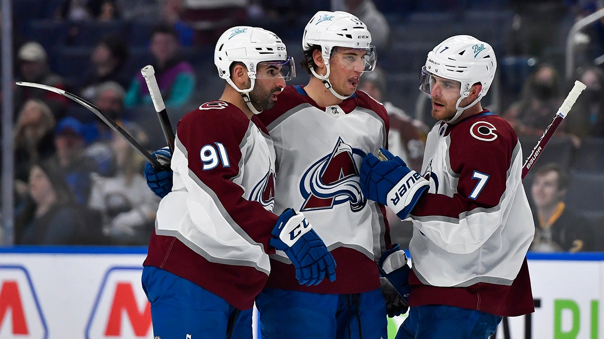 Colorado Avalanche center Nazem Kadri, left, celebrates with left wing Andre Burakovsky, center and defenseman Devon Toews after scoring against the Buffalo Sabres during the first period of an NHL hockey game in Buffalo, N.Y., Saturday, Feb. 19, 2022.