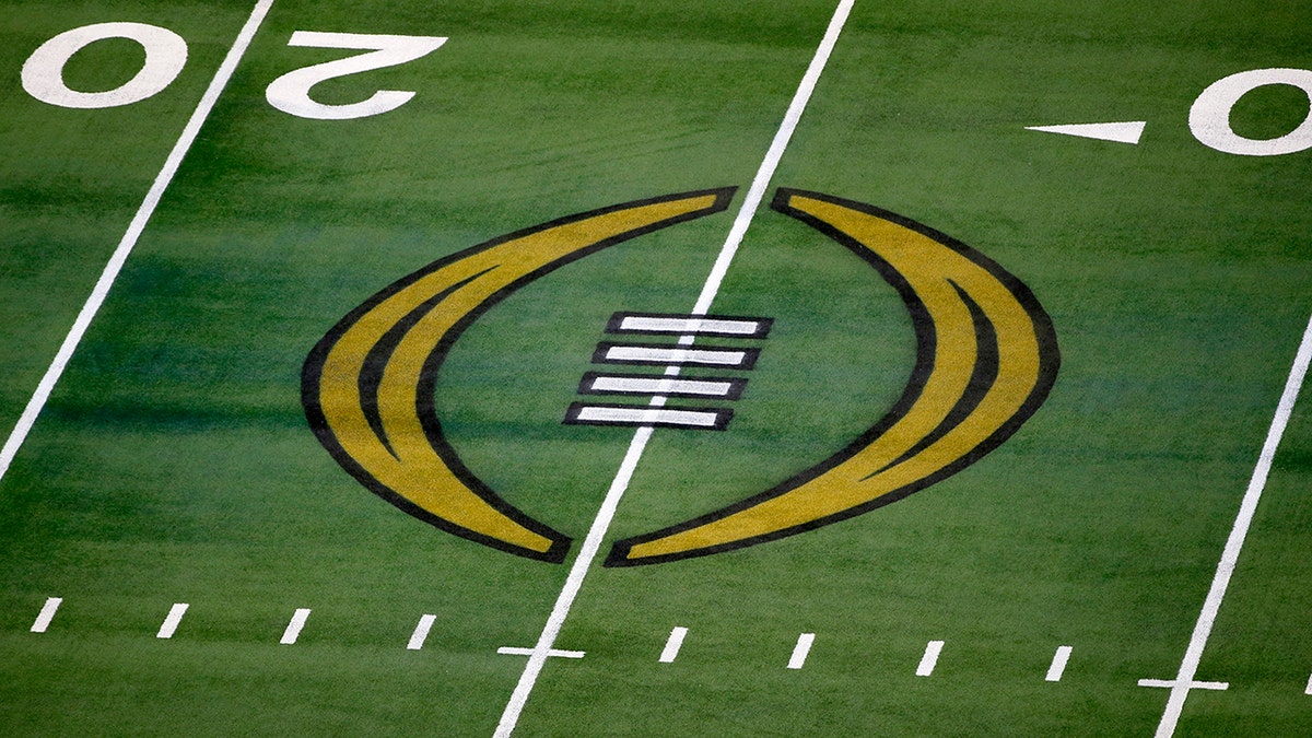 FILE - The College Football Playoff logo is shown on the field at AT&amp;T Stadium before an NCAA college football game in Arlington, Texas, Jan. 1, 2021. The College Football Playoff is set to remain a four-team format through the 2025 season after the administrators who manage the postseason failed to agree on an expansion plan before the current contracts run out. A person involved with the decision told The Associated Press on Friday, Feb. 18, 2022, that the CFP management committee, comprised of 10 conference commissioners and Notre Dame’s athletic director, met by video conference earlier this week.