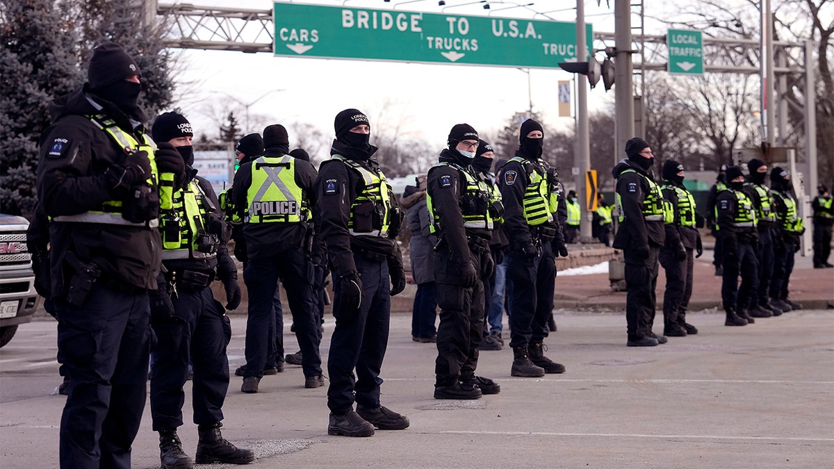 Canadian police wearing neon vests and winter gear in preparation for the trucker protests