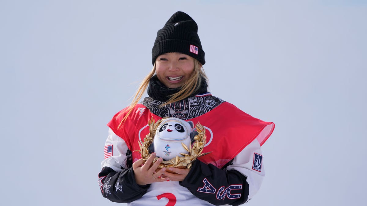 Gold medal winner the United States' Chloe Kim celebrates during the venue ceremony for the women's halfpipe at the 2022 Winter Olympics, Thursday, Feb. 10, 2022, in Zhangjiakou, China. 