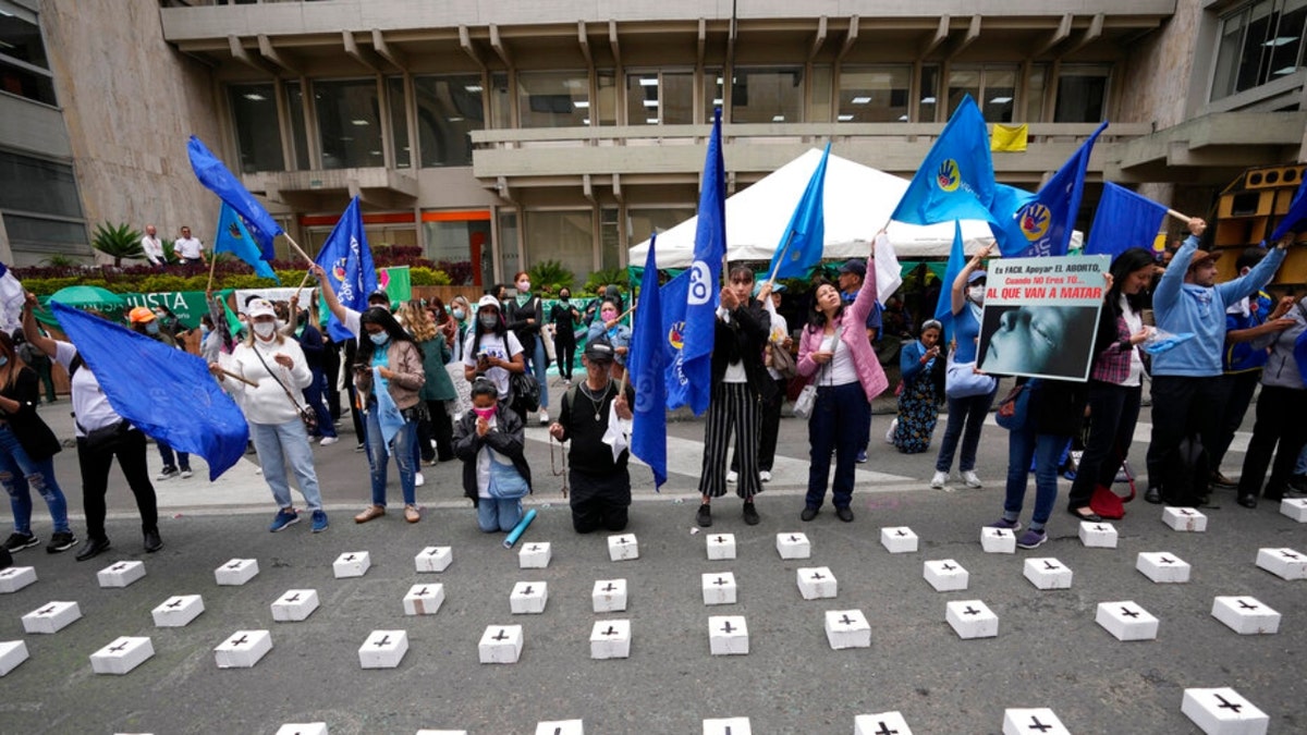 Anti-abortion activists protest outside the Constitutional Court where they placed tiny, symbolic coffins as judges continue discussions on the decriminalization of abortion in Bogota, Colombia, Monday, Feb. 21, 2022.
