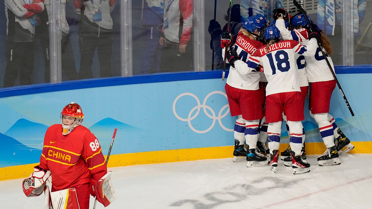 Czech Republic players celebrate after scoring a goal against China goalkeeper Tiya Chen (88) during a preliminary round women's hockey game at the 2022 Winter Olympics, Thursday, Feb. 3, 2022, in Beijing.