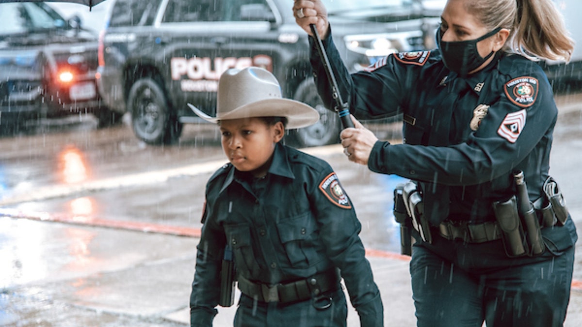 Devarjaye "DJ" Daniel, 10, is sworn into his 100th law enforcement agency. (Houston Independent School District)