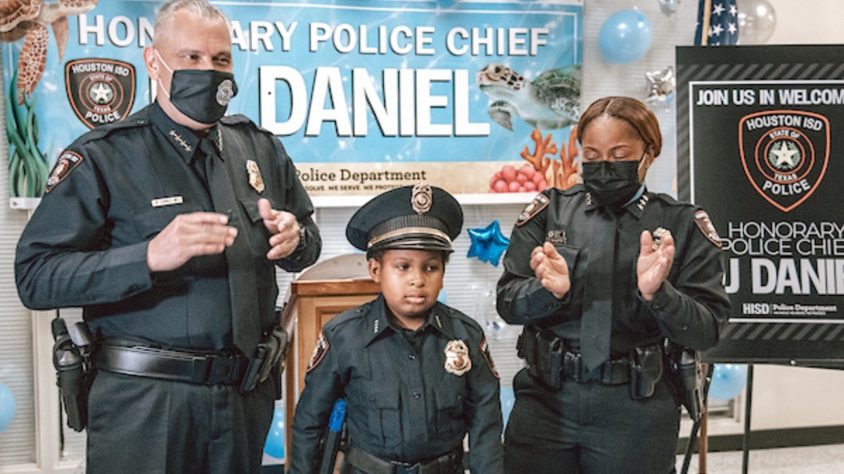 Devarjaye "DJ" Daniel, 10, is sworn into his 100th law enforcement agency. (Houston Independent School District)