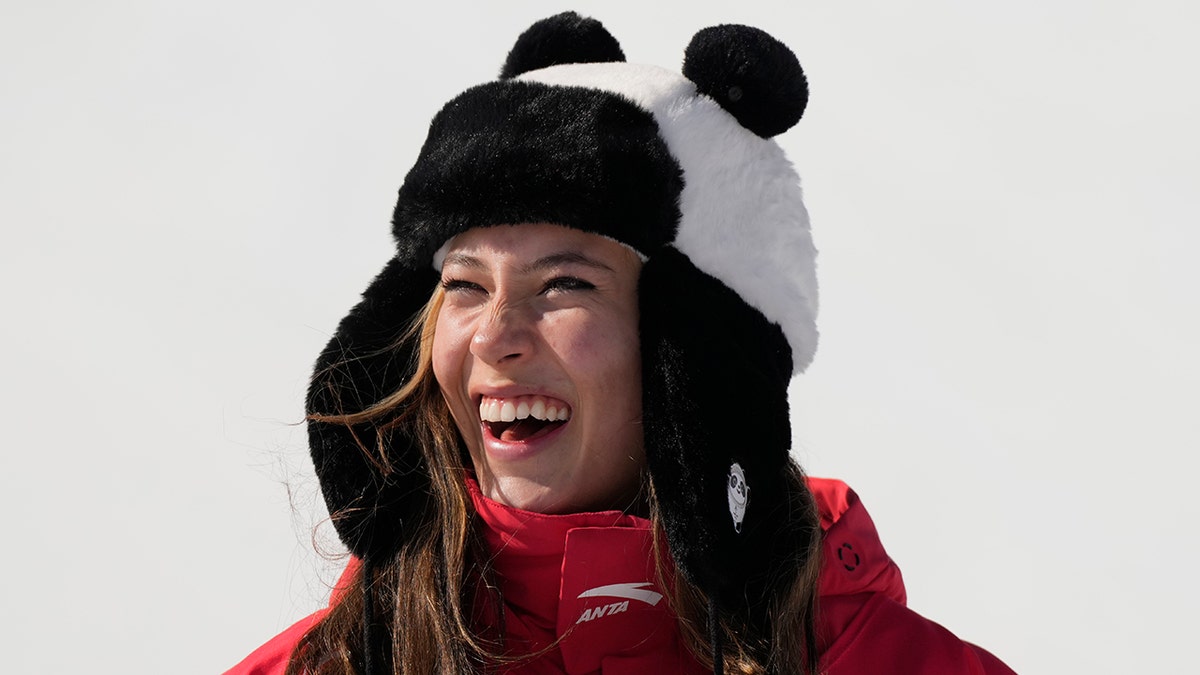 Gold medal winner China's Eileen Gu celebrates during the venue award ceremony for the women's halfpipe finals at the 2022 Winter Olympics, Friday, Feb. 18, 2022, in Zhangjiakou, China.