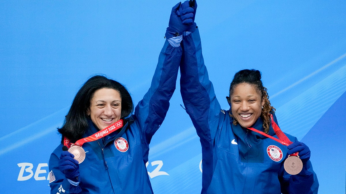 Elana Meyers Taylor and Sylvia Hoffman of the United States celebrate winning the bronze medal in the women's bobsled at the 2022 Winter Olympics, Saturday, Feb. 19, 2022, in the Yanqing district of Beijing.