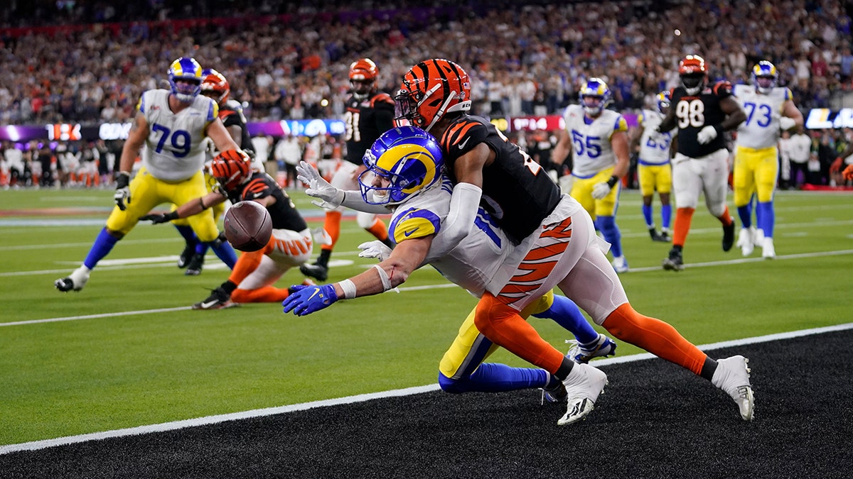Los Angeles Rams wide receiver Cooper Kupp, bottom, can't catch a pass as he's held by Cincinnati Bengals cornerback Eli Apple during the second half of the NFL Super Bowl 56 football game Sunday, Feb. 13, 2022, in Inglewood, California.