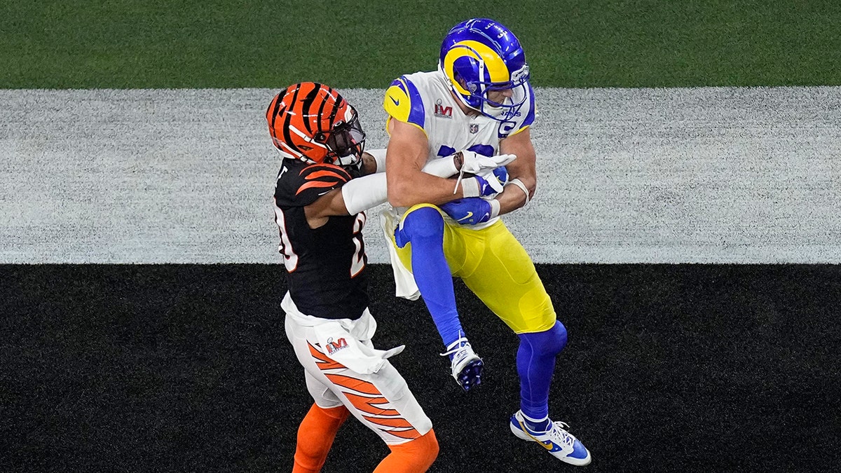 Los Angeles Rams wide receiver Cooper Kupp grabs a touchdown pass as Cincinnati Bengals cornerback Eli Apple makes the tackle during the second half of the NFL Super Bowl 56 football game, Sunday, Feb. 13, 2022, in Inglewood, California.