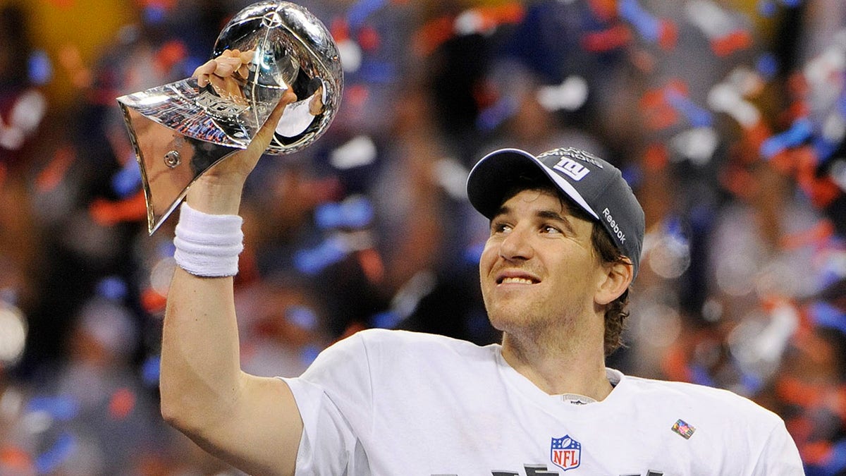 Quarterback Eli Manning of the New York Giants celebrates holding up the Vince Lombardi Trophy after they defeated the New England Patriots in Super Bowl XLVI, Feb. 5, 2012, at Lucas Oil Stadium in Indianapolis. The Giants won 21-17.