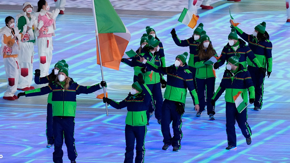 Elsa Desmond and Brendan Newby, of Ireland, carry their country's flag during the opening ceremony of the 2022 Winter Olympics, Friday, Feb. 4, 2022, in Beijing. (AP Photo/Bernat Armangue)