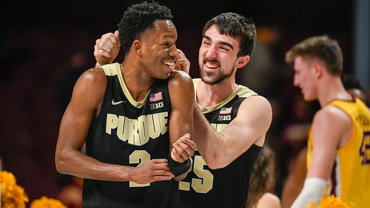 Purdue guard Eric Hunter Jr., left celebrates with guard Ethan Morton after the team's 88-73 win over Minnesota during an NCAA college basketball game Wednesday, Feb. 2, 2022, in Minneapolis.