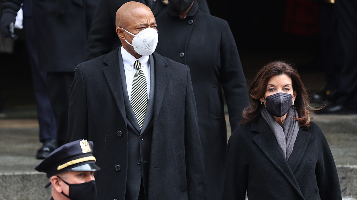 New York City Mayor Eric Adams and New York Gov. Kathy Hochul leave the funeral for fallen NYPD officer Wilbert Mora at St. Patrick's Cathedral on Feb. 2, 2022, in New York City.