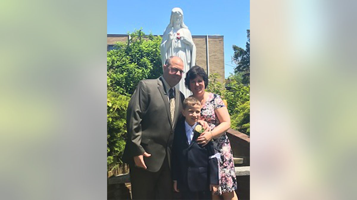 In this family photo snapped in 2019, Frank and Joan Thomas of Brooklyn, New York, celebrate their youngest son Joseph's First Holy Communion.