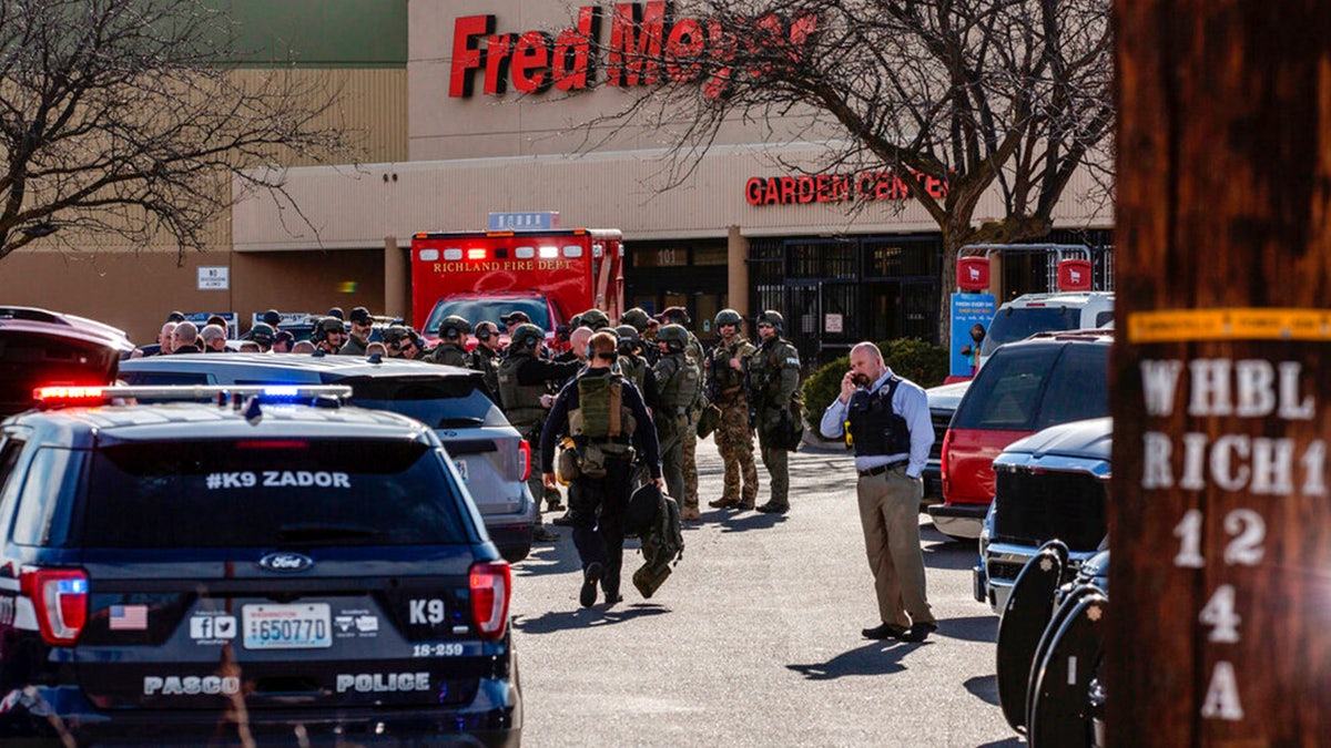 Authorities stage outside a Fred Meyer grocery store after a fatal shooting at the business on Wellsian Way in Richland, Wash., Monday, Feb. 7, 2022. 