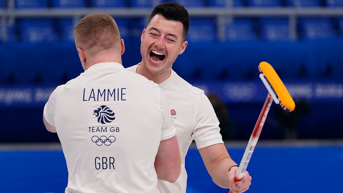 Britain's Hammy McMillan celebrates with Bobby Lammie after winning the men's curling semifinal match against the United States at the Beijing Winter Olympics Thursday, Feb. 17, 2022, in Beijing.