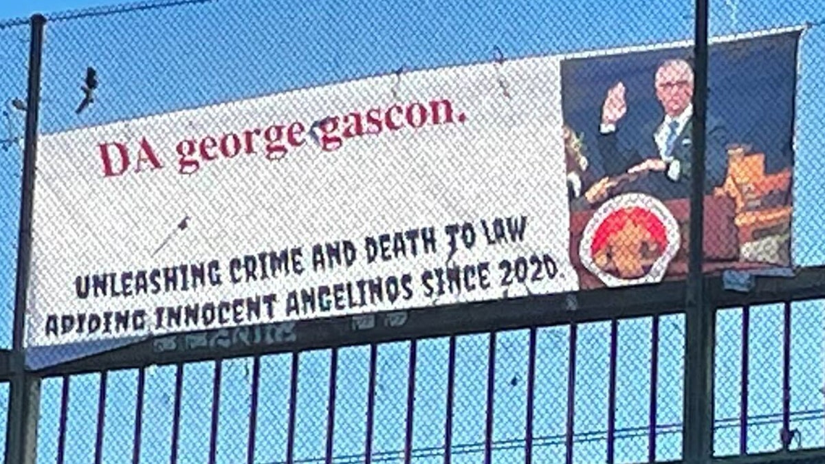 An anti-Gascon sign hangs from a freeway overpass