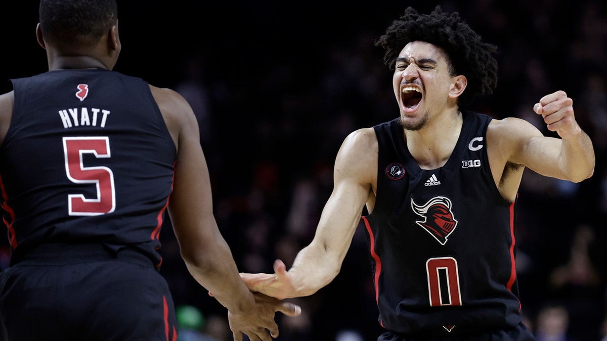 Rutgers guard Geo Baker (0) celebrates with Aundre Hyatt during the second half of the team's NCAA college basketball game against Illinois on Wednesday, Feb. 16, 2022, in Piscataway, N.J.